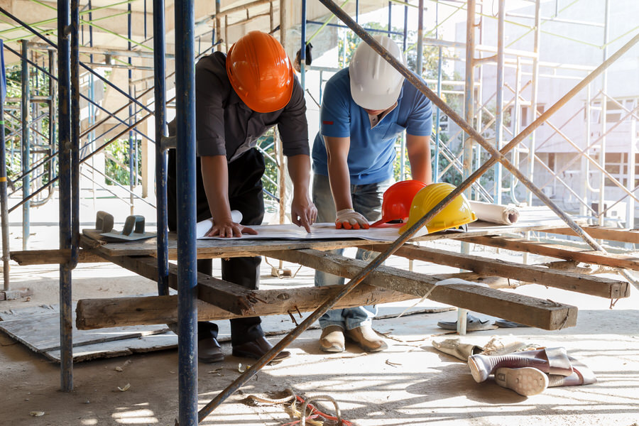 Engineer discussing with foreman about project in building const